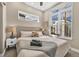 Sunlit bedroom features a large window, plush bedding, and modern bedside tables at 3219 W 19Th Ave # 4, Denver, CO 80204