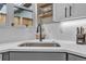 A close-up of a well-lit kitchen sink with modern fixtures and attractive backsplash at 3219 W 19Th Ave # 4, Denver, CO 80204