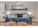 Living room featuring a comfortable blue sofa with decoratively-pillowed cushions and rustic shelving at 3219 W 19Th Ave # 4, Denver, CO 80204