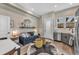 Cozy living room with a blue sofa, industrial style shelf, and decorative mirror and furnishings at 3219 W 19Th Ave # 4, Denver, CO 80204