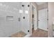 Modern walk-in shower featuring white subway tile, a built-in niche, and a sleek glass door at 3219 W 19Th Ave # 4, Denver, CO 80204