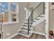 Bright stairway featuring modern railing, hardwood floors, and natural light from a large window at 3219 W 19Th Ave # 4, Denver, CO 80204