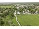 A scenic aerial view captures the neighborhood with lush greenery and diverse homes nestled amongst mature trees at 11762 W 34Th Ave, Wheat Ridge, CO 80033