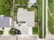 An aerial view shows the house layout, landscaped yard and nearby trail at 11762 W 34Th Ave, Wheat Ridge, CO 80033