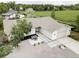 Aerial view of the home shows manicured front yard with patio furniture and a long driveway leading to a three car garage at 11762 W 34Th Ave, Wheat Ridge, CO 80033