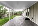 A covered back patio with stone floor and lush backyard offers an ideal space for outdoor living and entertaining at 11762 W 34Th Ave, Wheat Ridge, CO 80033