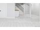 Open basement space with plush carpet, white walls, and staircase with iron railing at 11762 W 34Th Ave, Wheat Ridge, CO 80033