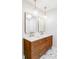 Modern bathroom with a double vanity, stylish mirrors, and globe pendant lights at 11762 W 34Th Ave, Wheat Ridge, CO 80033
