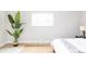 Bright bedroom features a potted plant, window, and clean minimalistic design at 11762 W 34Th Ave, Wheat Ridge, CO 80033