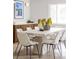 Bright dining room featuring a large table, seating for eight, and modern decor at 11762 W 34Th Ave, Wheat Ridge, CO 80033