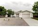 Charming single-story home featuring a neutral color palette, gravel front yard, and attached two-car garage at 11762 W 34Th Ave, Wheat Ridge, CO 80033