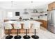 Modern kitchen featuring a large island with bar seating, stainless steel appliances, and stylish pendant lights at 11762 W 34Th Ave, Wheat Ridge, CO 80033
