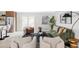 Bright and open-concept living room with kitchen bar and an abundance of seating at 11762 W 34Th Ave, Wheat Ridge, CO 80033