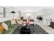 Open-concept living room with modern decor, hardwood floors, and ample natural light at 11762 W 34Th Ave, Wheat Ridge, CO 80033