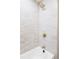 Bright shower features white tile, gold fixtures, and a modern shower head at 11762 W 34Th Ave, Wheat Ridge, CO 80033