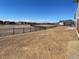 Spacious, flat backyard with a metal fence surrounding the perimeter of the property at 16562 E 109Th Ave, Commerce City, CO 80022