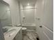 Clean, all-white bathroom with a tub and shower combination at 16562 E 109Th Ave, Commerce City, CO 80022