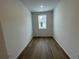 This bedroom features wood-look flooring and a large window for natural light at 16562 E 109Th Ave, Commerce City, CO 80022