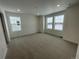 Well-lit bedroom with neutral carpet, white walls, and large windows with neighborhood views at 16562 E 109Th Ave, Commerce City, CO 80022