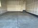 Spacious two-car garage with unfinished drywall and concrete flooring at 16562 E 109Th Ave, Commerce City, CO 80022