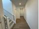 Bright hallway with hardwood flooring and a staircase at 16562 E 109Th Ave, Commerce City, CO 80022