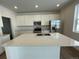 Kitchen island with seating and a stainless steel sink at 16562 E 109Th Ave, Commerce City, CO 80022