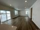 Bright living room with hardwood floors and sliding glass doors at 16562 E 109Th Ave, Commerce City, CO 80022