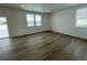 Spacious living room with hardwood floors and large windows at 16562 E 109Th Ave, Commerce City, CO 80022