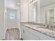 Bathroom featuring granite countertops, double sinks, and wood-style flooring for a modern aesthetic at 22123 E 38Th Pl, Aurora, CO 80019
