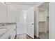 Bathroom with granite countertop vanity, with an open closet and bathroom access at 22123 E 38Th Pl, Aurora, CO 80019