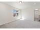 A bright bedroom featuring a large window, plush carpeting, and white walls at 22123 E 38Th Pl, Aurora, CO 80019