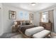 Modern bedroom with neutral tones, wood furniture, and ample natural light for a serene atmosphere at 22123 E 38Th Pl, Aurora, CO 80019