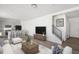Open-concept living room and kitchen with modern furnishings, hardwood flooring, and staircase at 22123 E 38Th Pl, Aurora, CO 80019