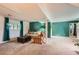 Finished basement area with carpeted floors, green accent wall, sofa, armchair, and window for natural light at 19196 E Kansas Dr, Aurora, CO 80017