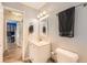 Bathroom with grey walls, white cabinets, modern fixtures, towel racks, and access to a bedroom at 19196 E Kansas Dr, Aurora, CO 80017