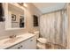 Bathroom features white cabinets, a speckled granite countertop, a grey towel, and a patterned shower curtain at 19196 E Kansas Dr, Aurora, CO 80017