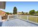 Outdoor deck with white railing overlooking the backyard and providing an ideal spot for relaxation at 19196 E Kansas Dr, Aurora, CO 80017
