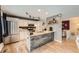Stylish kitchen featuring an island, stainless steel appliances, and modern lighting fixtures at 19196 E Kansas Dr, Aurora, CO 80017