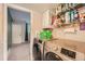 Convenient laundry room featuring a modern, front-loading washer and dryer set with storage shelves at 19196 E Kansas Dr, Aurora, CO 80017