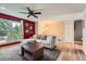 Bright living room with large window, comfortable seating, and modern ceiling fan at 19196 E Kansas Dr, Aurora, CO 80017