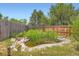 Backyard pond landscaped with rocks and greenery, creating a tranquil outdoor retreat at 19196 E Kansas Dr, Aurora, CO 80017