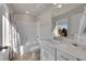 Bright bathroom featuring a bathtub with a shower, vanity with sink, and modern fixtures at 5738 N Vivian St, Arvada, CO 80002