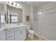 Modern bathroom featuring a vanity with sink and mirror, toilet, and a glass-enclosed shower with chrome hardware at 5738 N Vivian St, Arvada, CO 80002