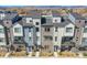 An exterior view of modern townhomes featuring neutral colors, balconies, and mountain views in the background at 5738 N Vivian St, Arvada, CO 80002
