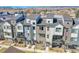 Modern townhomes featuring a blend of brick and siding, complemented by private balconies with mountain views at 5738 N Vivian St, Arvada, CO 80002