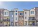 Modern townhomes featuring balconies and diverse exterior materials, creating appealing street views on a sunny day at 5738 N Vivian St, Arvada, CO 80002