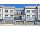 Modern townhome facades showcase private garages and balconies under clear blue skies, offering stylish urban living at 5738 N Vivian St, Arvada, CO 80002
