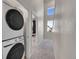 Hallway featuring a stacked washer and dryer and two windows for great natural light at 5738 N Vivian St, Arvada, CO 80002