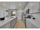 Bright kitchen featuring sleek countertops, stainless steel appliances, and ample cabinet space at 5738 N Vivian St, Arvada, CO 80002