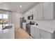 A gourmet kitchen features stainless steel appliances, ample counter space, and sleek white cabinetry at 5738 N Vivian St, Arvada, CO 80002